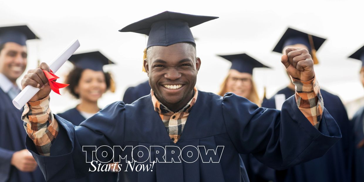 Man holding diploma celebrating his graduation with others from his class.