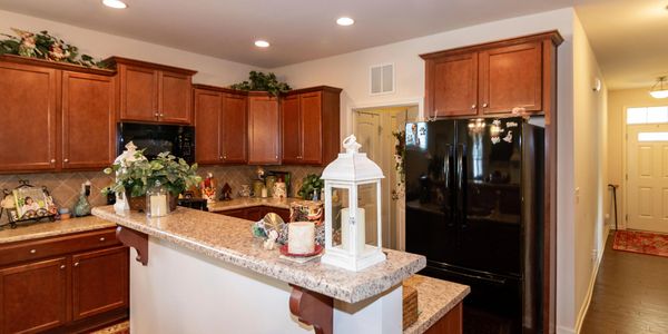 Cozy kitchen with wooden cabinets and a granite countertop.