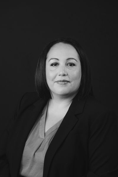 Black and white portrait of a woman in professional attire.