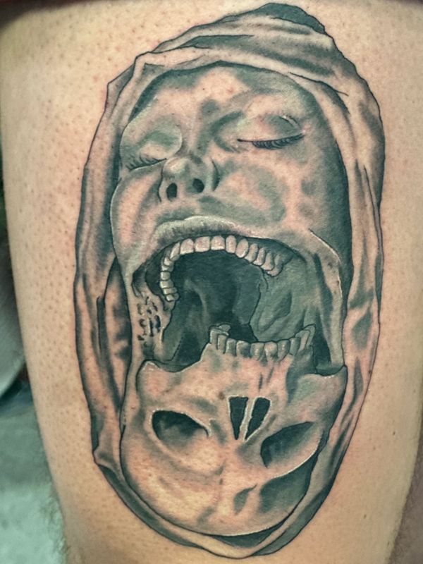 Black and gray surreal face and skull tattoo with illustrative shading and anatomical details.