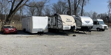 A car, truck and trailers stored outdoors in New Buffalo.