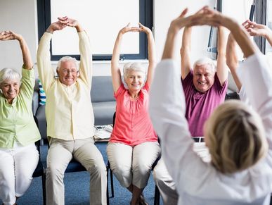 Elderly people exercising together 