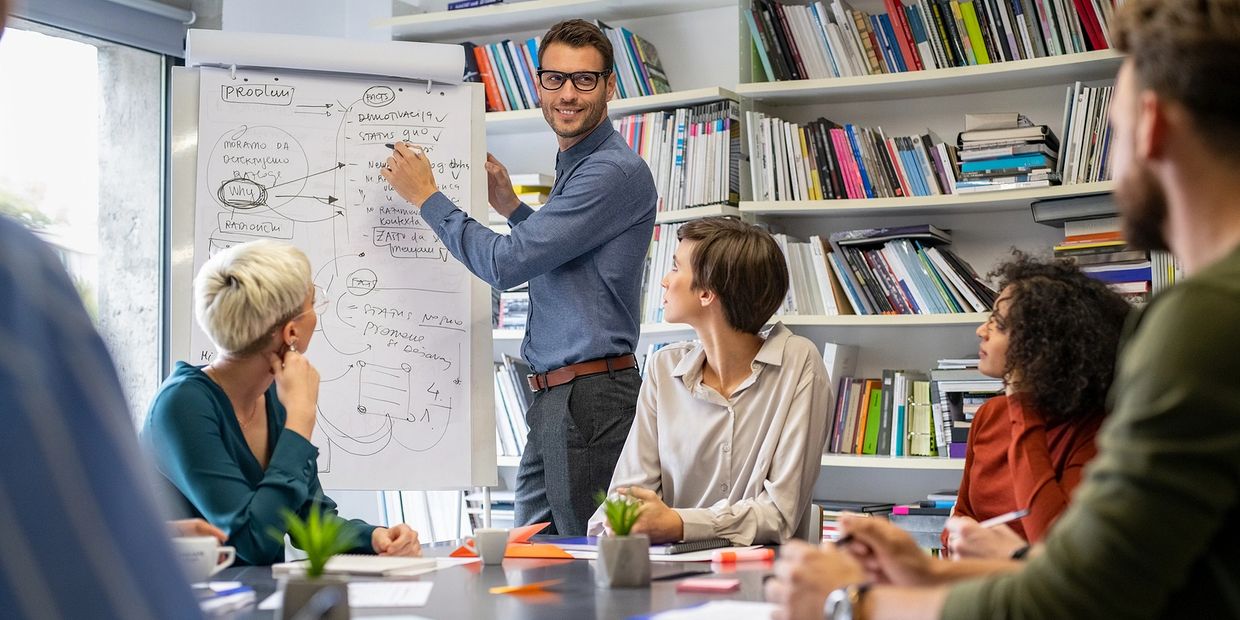 a man writing on the board and other looking 
