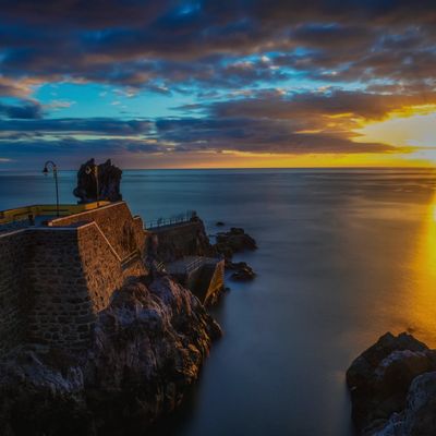 Sunset at the Pier of Ponta do Sol, a village on the southwest coast of Madeira Island, Portugal. 