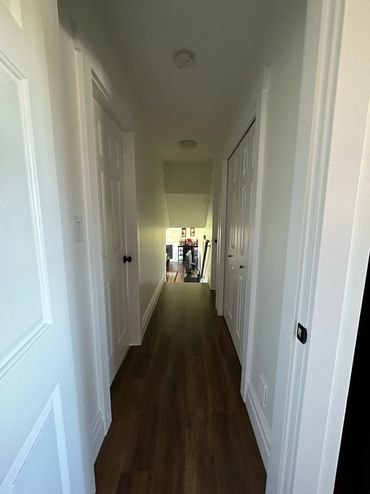 GVP Contracting Langley BC Interior Renovation hallway with new flooring and baseboard trims
