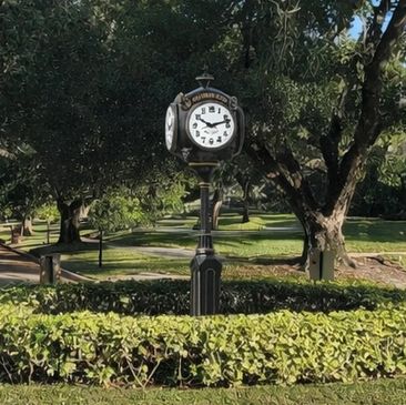 Old-fashioned clock in a green park.