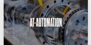 Close-up of industrial machinery with AT-AUTOMATION text overlay.