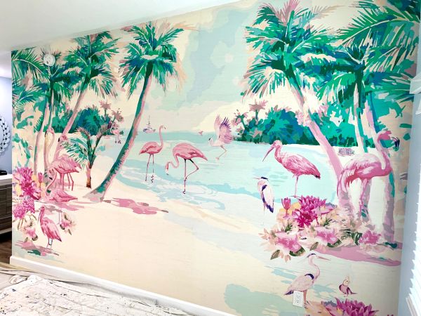 A vibrant tropical mural featuring flamingos, palm trees, and a serene beach scene.