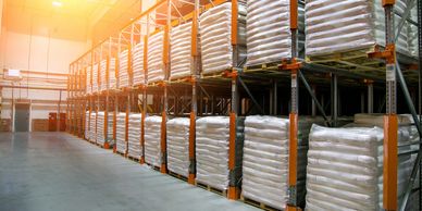 Pallets of thermoplastic resin bags in warehouse, ready to ship