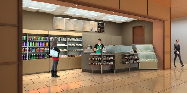 Small coffee shop counter with customers and a worker.