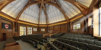 A spacious, wooden lecture hall with natural lighting.