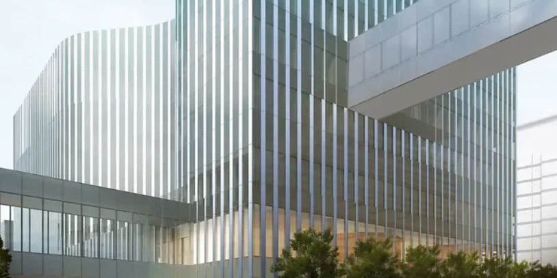 Modern glass building with connecting bridges.