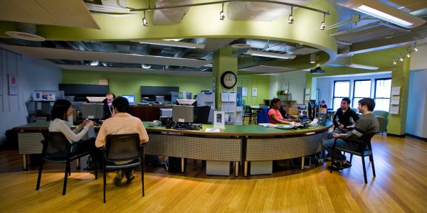 People working at a modern office desk setup.