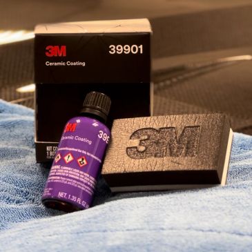 3M Ceramic Coating kit with bottle and applicator on a blue towel.