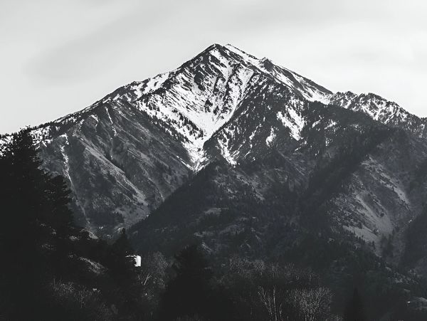 Snow-capped mountain peak in black and white photography.