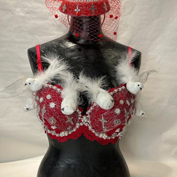Red embellished bra with white bird decorations and feathers.