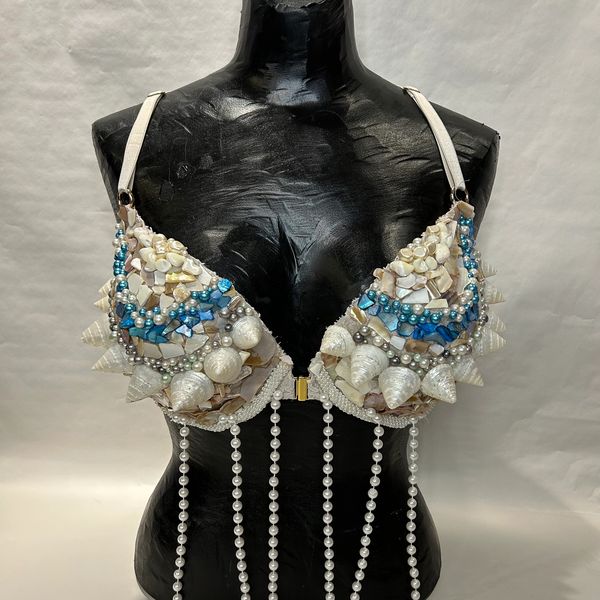 Decorative bra adorned with seashells and pearls.