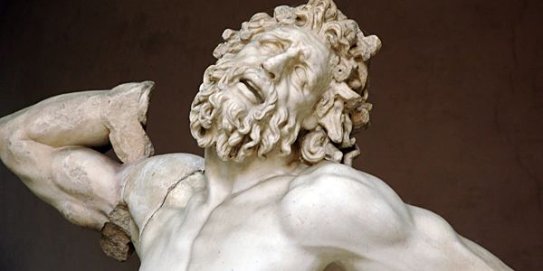 Ancient marble statue depicting a muscular man in agony.