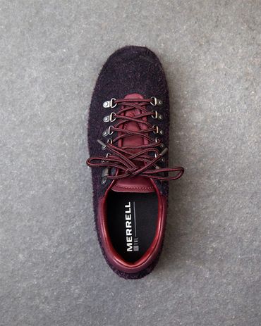 Top view of a maroon and black Merrell sneaker on a grey surface.