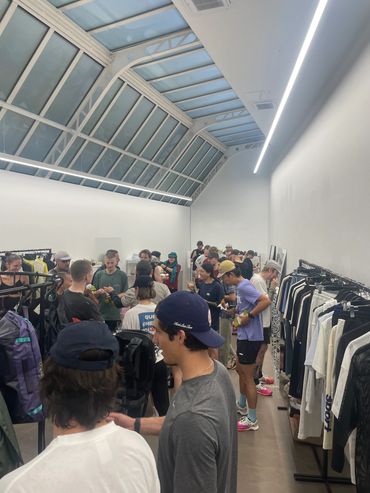People shopping in a modern clothing store with skylights.