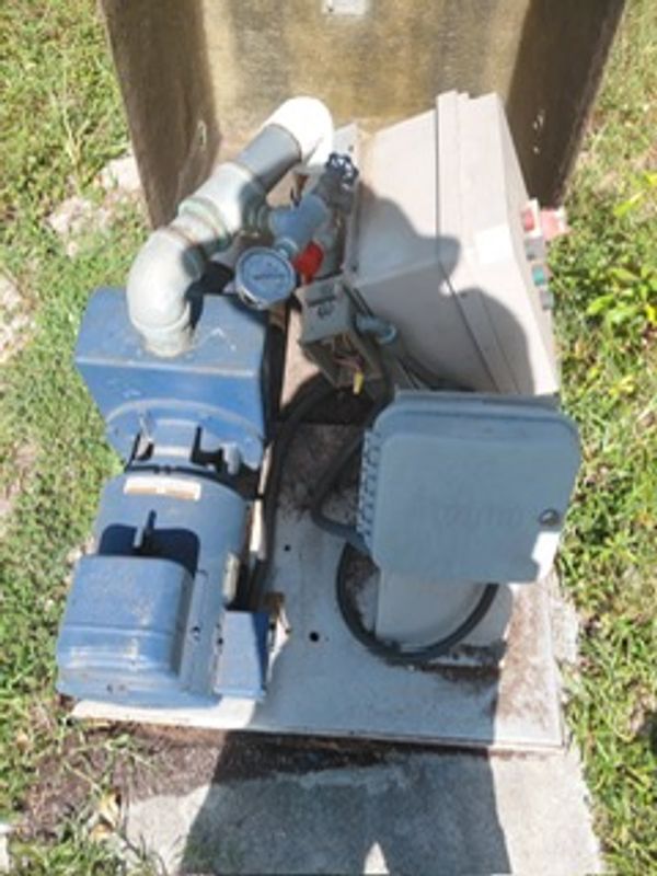Industrial pump system with pressure gauge outdoors.
