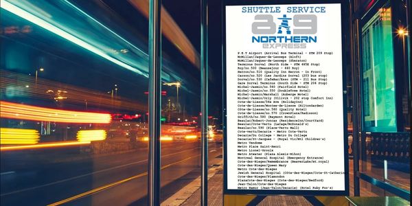 Bus stop sign listing shuttle service routes and stops at night.