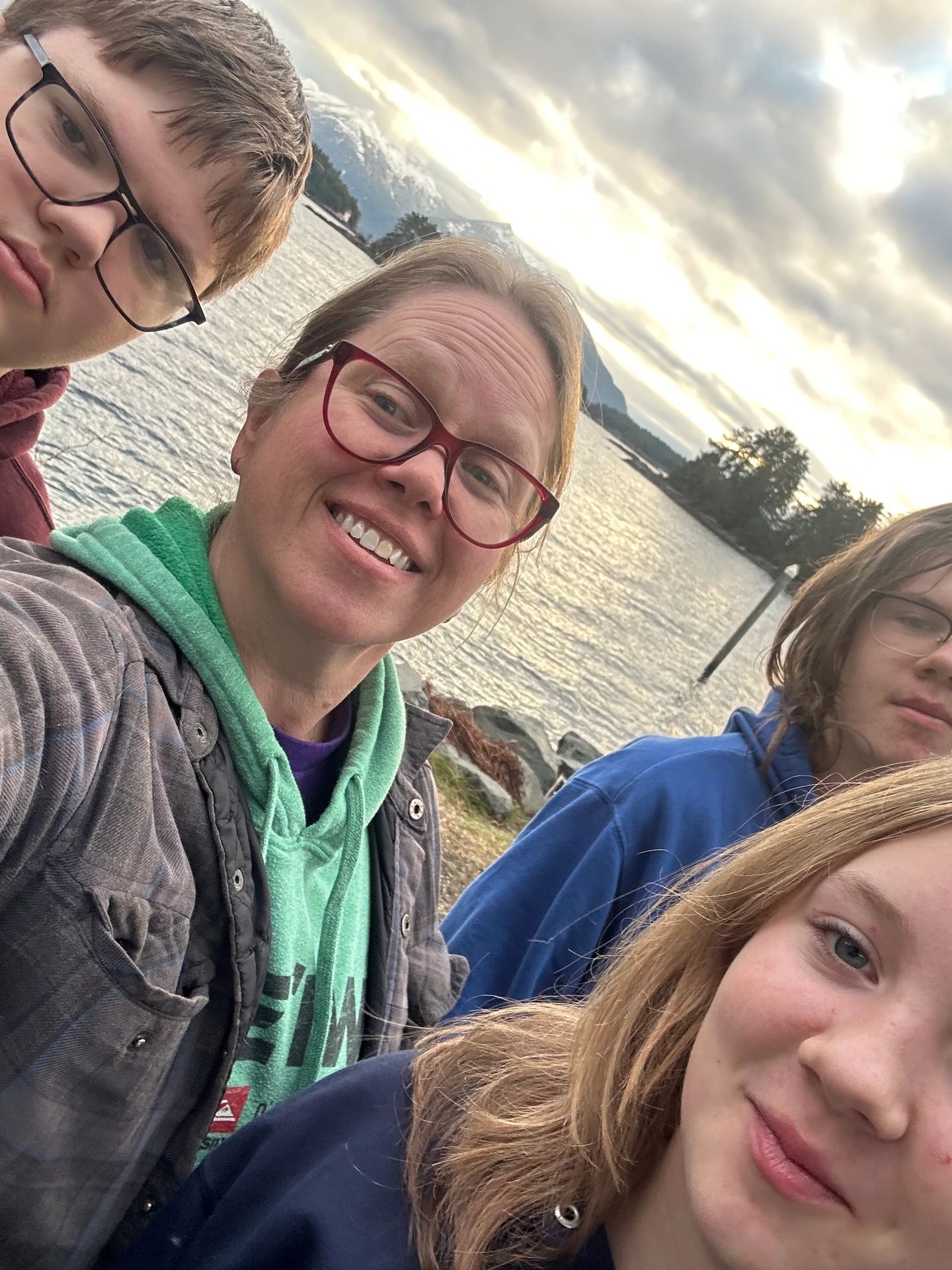 Karyn and her three children smile on a beach in Sitka, Alaska