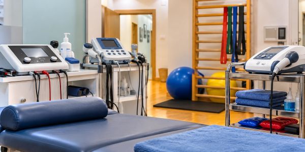 Physical therapy room with medical equipment and treatment table.
