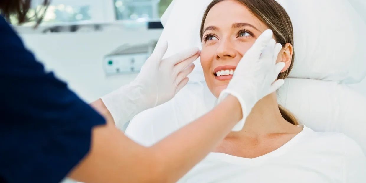 Woman receiving a facial examination from a healthcare professional.