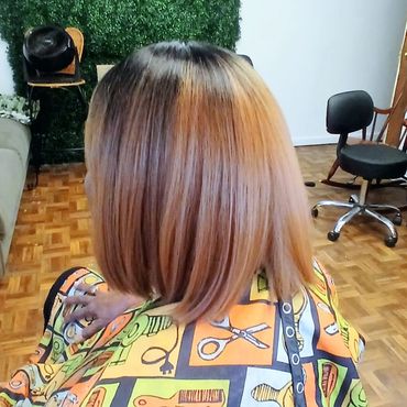 Woman with a fresh, straight bob haircut sitting in a salon.