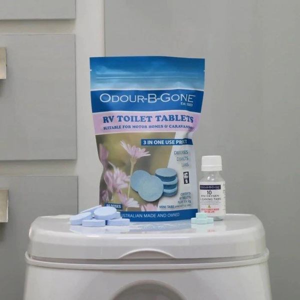 Odour-B-Gone RV toilet tablets and mini oxygen cleaning tabs on a white surface.