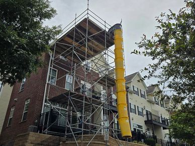 Debris chute attached to a system scaffolding set on a residential building in Saint Paul, MN.