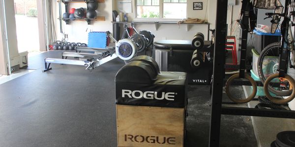 Home gym setup with rowing machines and strength training equipment.