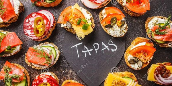 Selection of tapas on a slate serving tray.