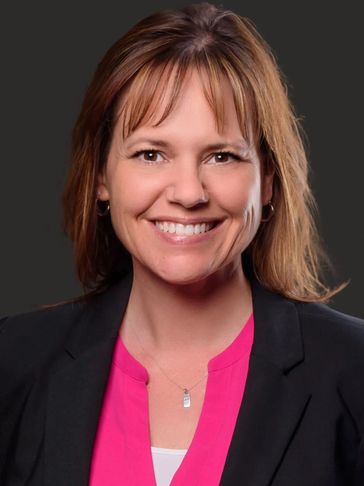 Smiling woman in business attire.