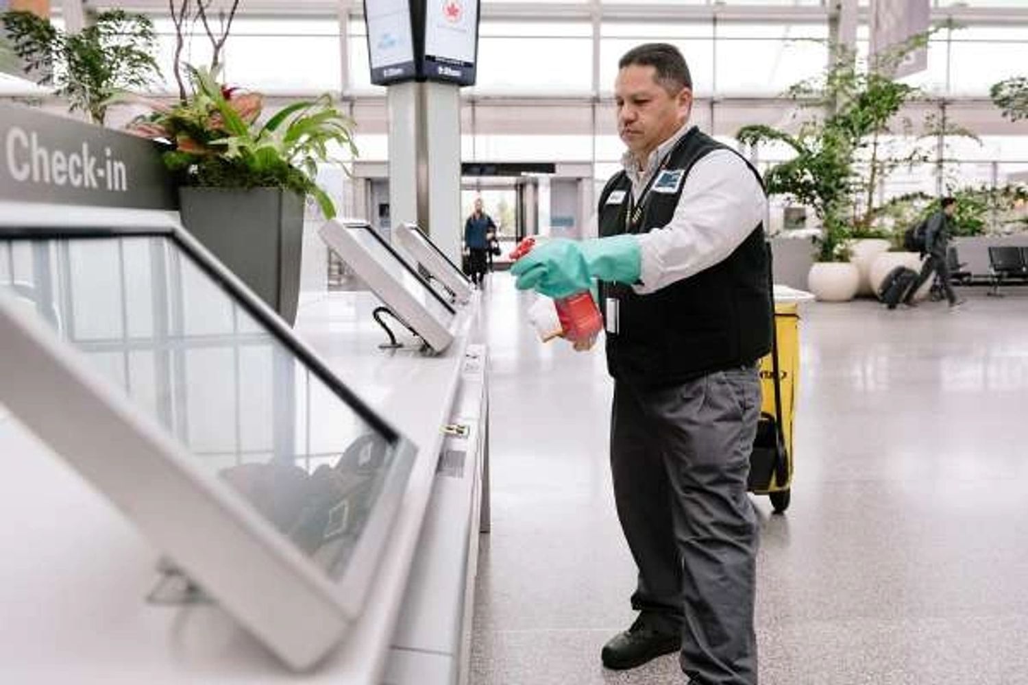 Worker disinfecting , cleaning front desk.