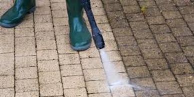 Worker Using  Power Washing on Bricks