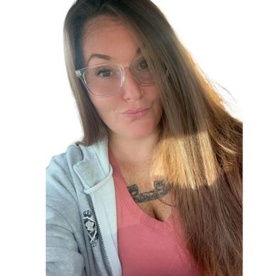 Young woman with long hair and glasses.