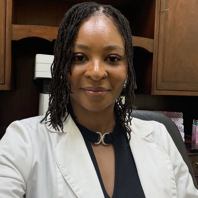 Smiling woman in a white coat in an office.