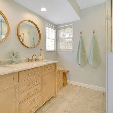 New construction bathroom remodel with light oak 60" vanity, countertops and brushed gold fixtures