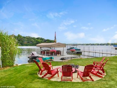 lakeside fire pit with boats and boardwalk