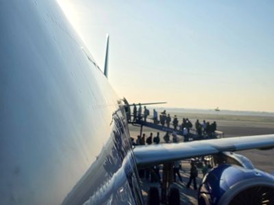Passengers boarding a plane at the airport.