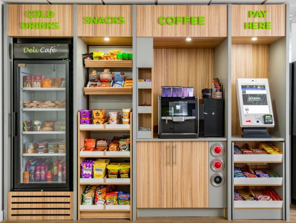 Modern smart micro markets with a variety of snacks and drinks station options with self check-out kiosks.