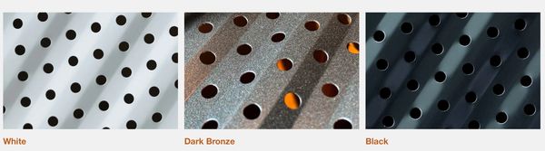 Close-up of perforated metal sheets in white, dark bronze, and black finishes.