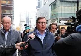 Nangle arrives in federal courtroom in handcuffs and shackles, pleads not-guilty