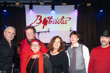A group of six musicians posing under a 'Bluesicles' banner.