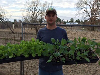 Farmer Joey with some of his bedding plants.