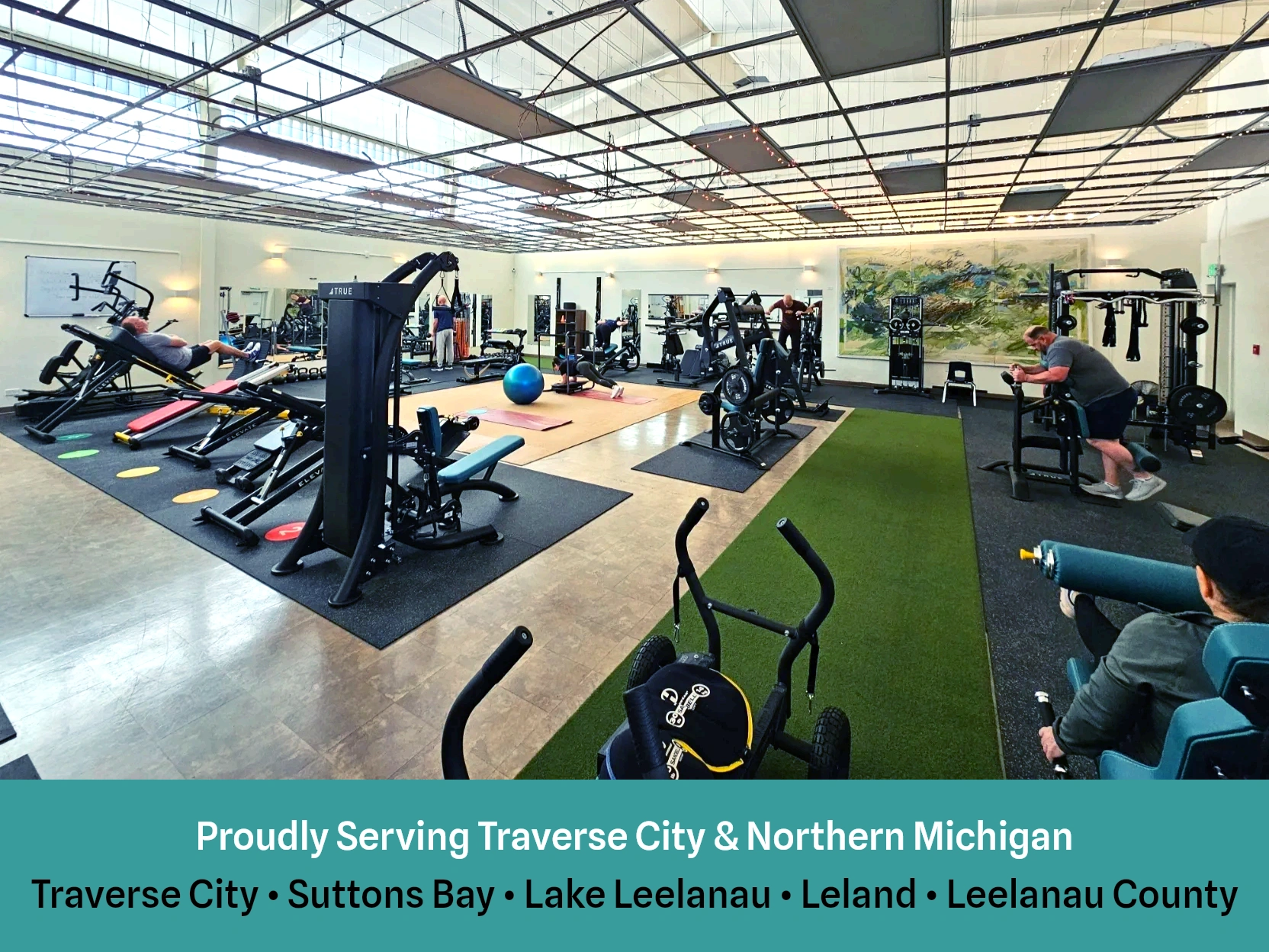 Main studio room with equipment and class members following the circuit.