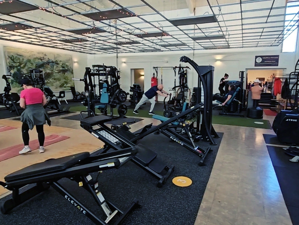 Image of the studio with members working out during one of the circuit classes. 