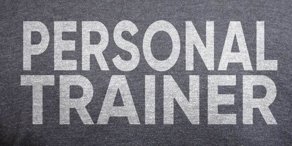 Back of a shirt with the words personal trainer.